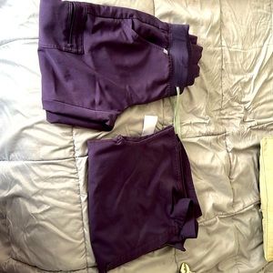 Figs scrubs, joggers and oversized scrub top in deep plum purple.